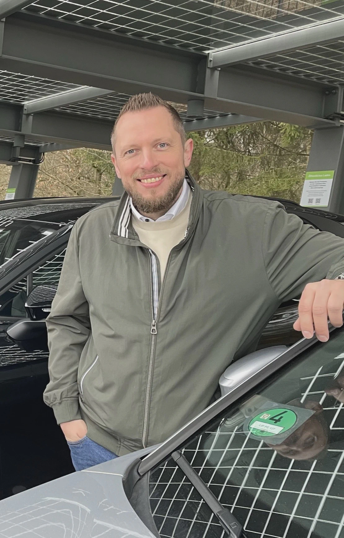 Christian Fiege is standing in front of EVSE in the AES Park of Phoenix Contact in Blomberg